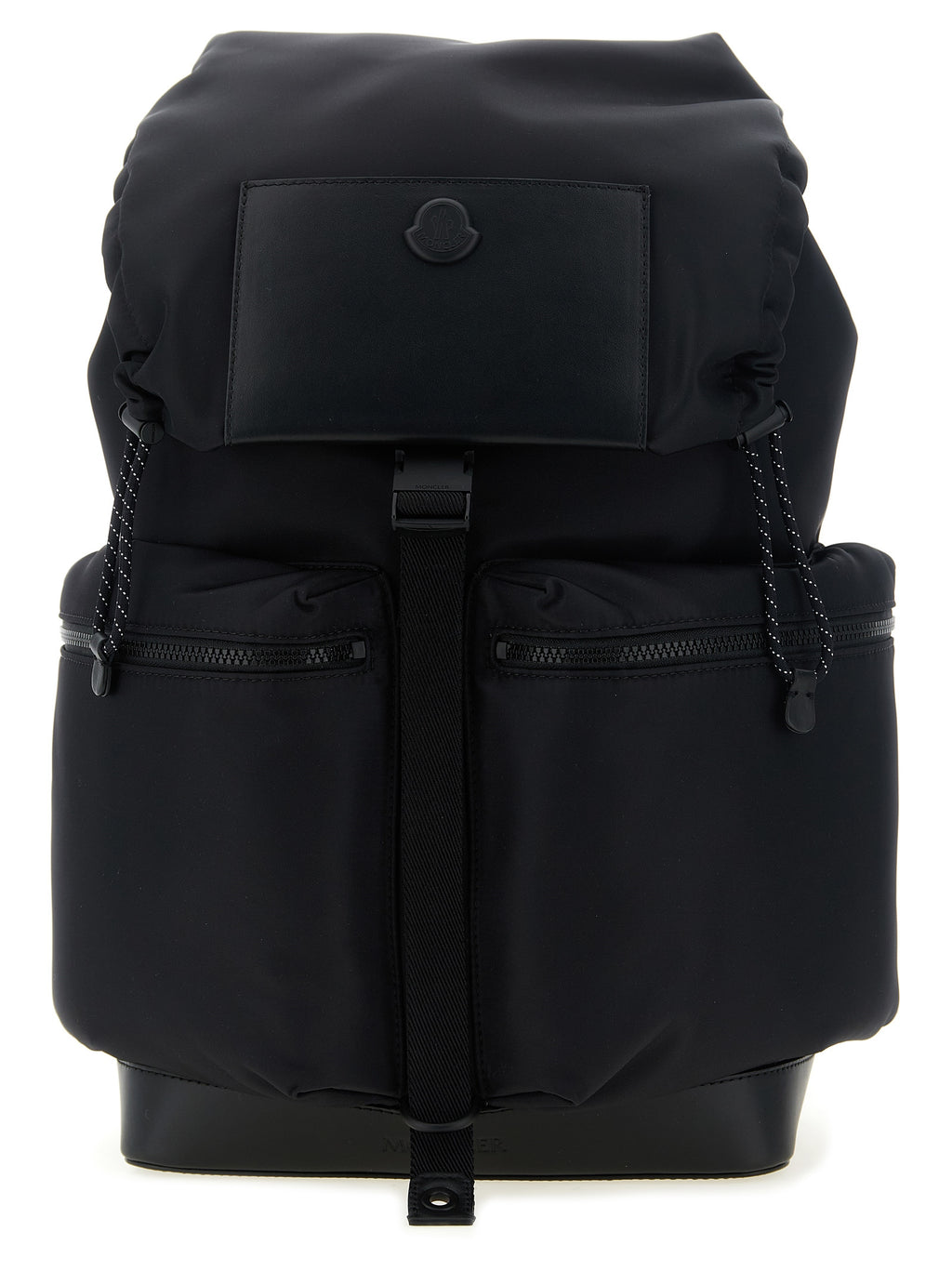 A black backpack with a top flap, two front zippered pockets, and a central vertical strap, photographed against a plain white background.