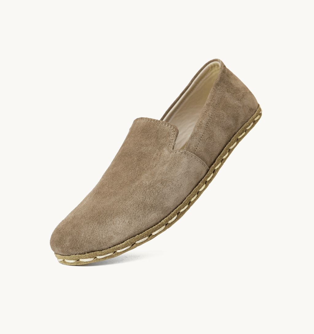 Beige Dawn women's barefoot leather loafer held in hand, sole and stitch detail