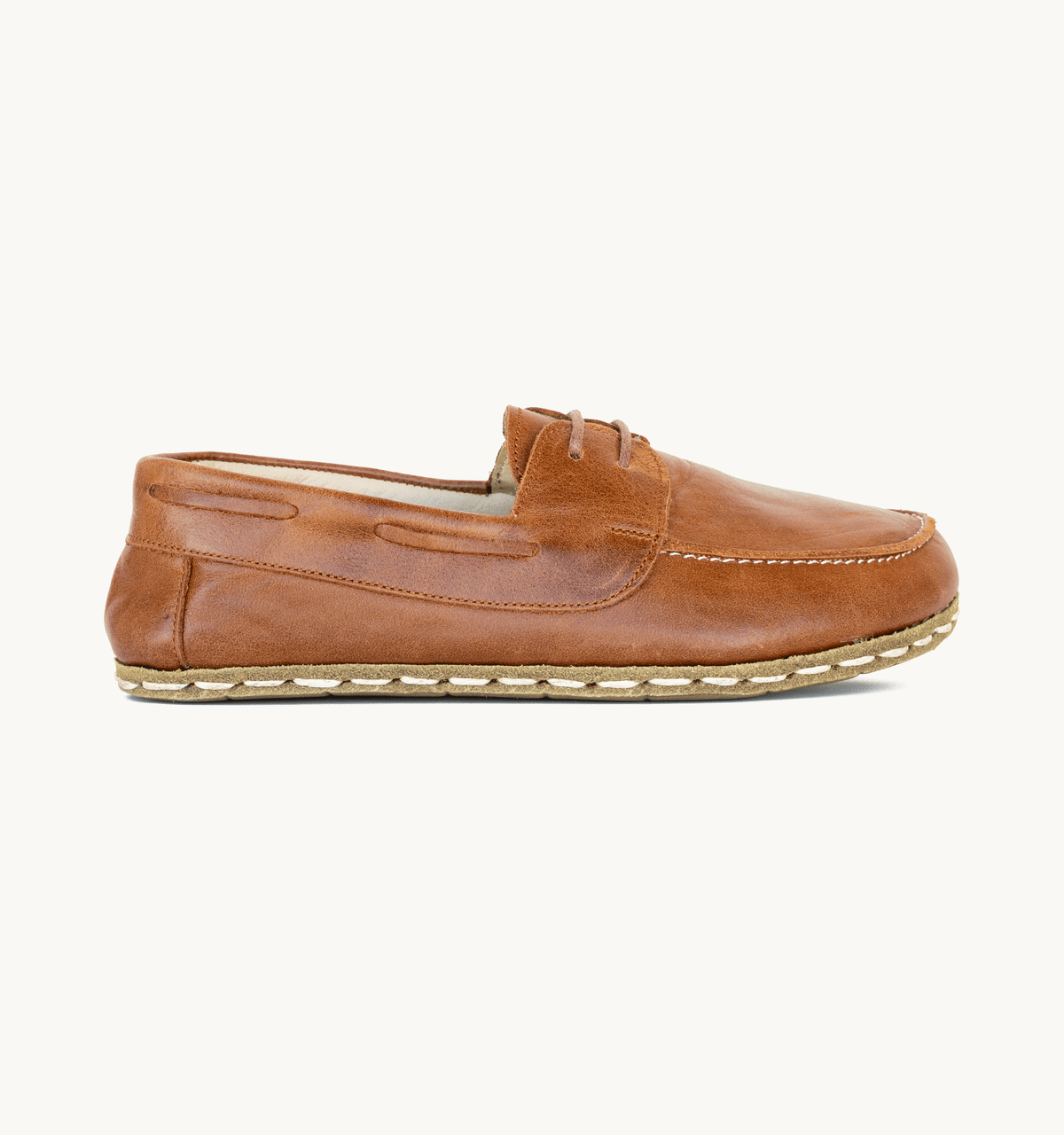 Russet women's barefoot leather boat shoe, side view — hand-stitched, zero drop