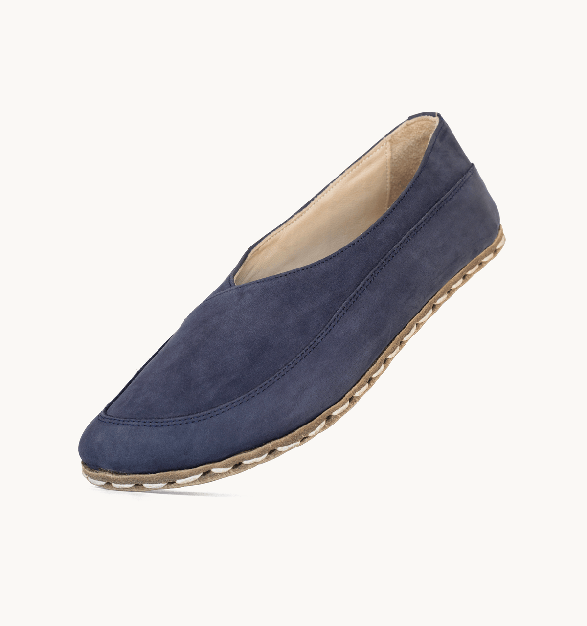 Navy women's barefoot leather flat, side view — hand-stitched, zero drop
