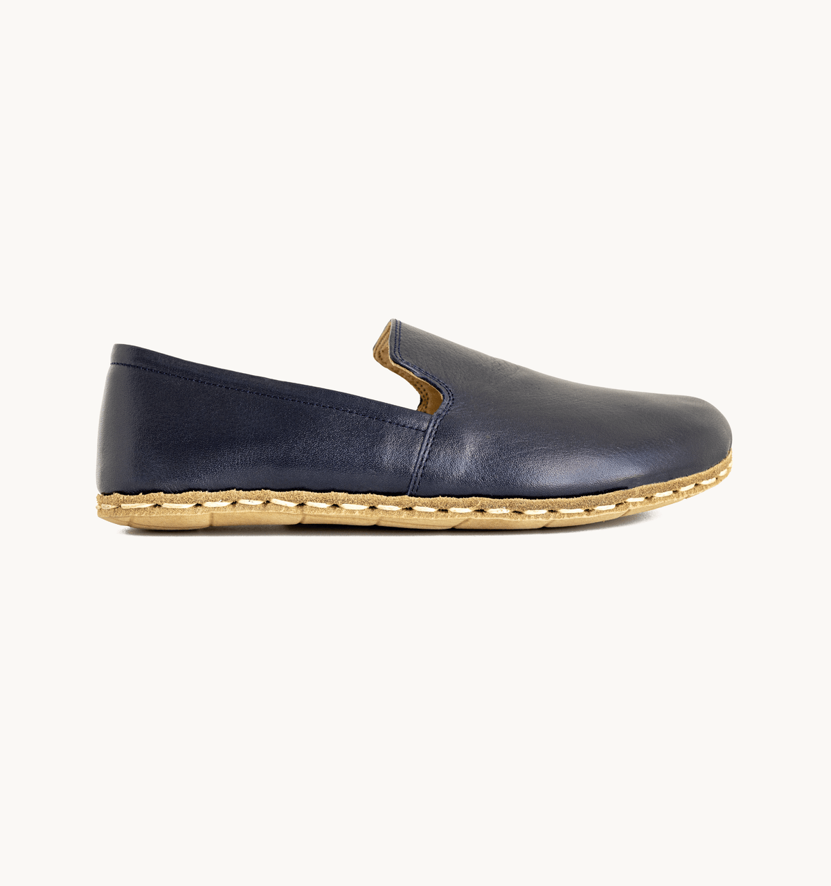 Indigo women's barefoot leather loafer, side view — hand-stitched, zero drop