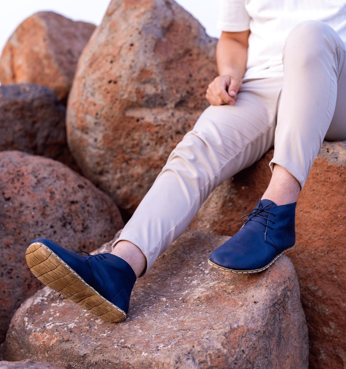 Ocean men's barefoot leather chukka boot held in hand, sole and stitch detail