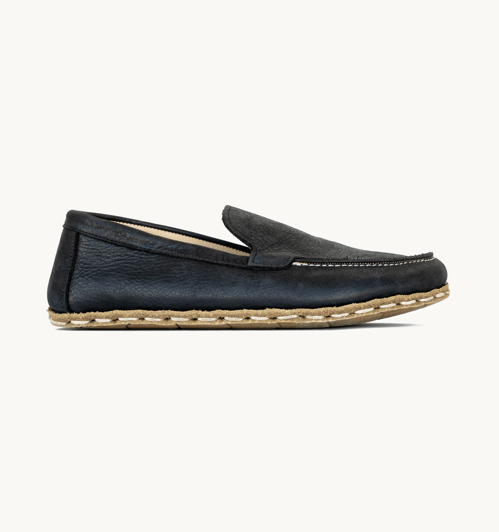 Raven Black women's barefoot leather moccasin, side view — hand-stitched, zero drop