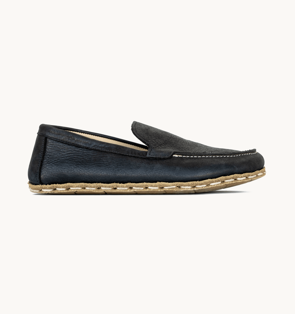 Raven Black women's barefoot leather moccasin, side view — hand-stitched, zero drop