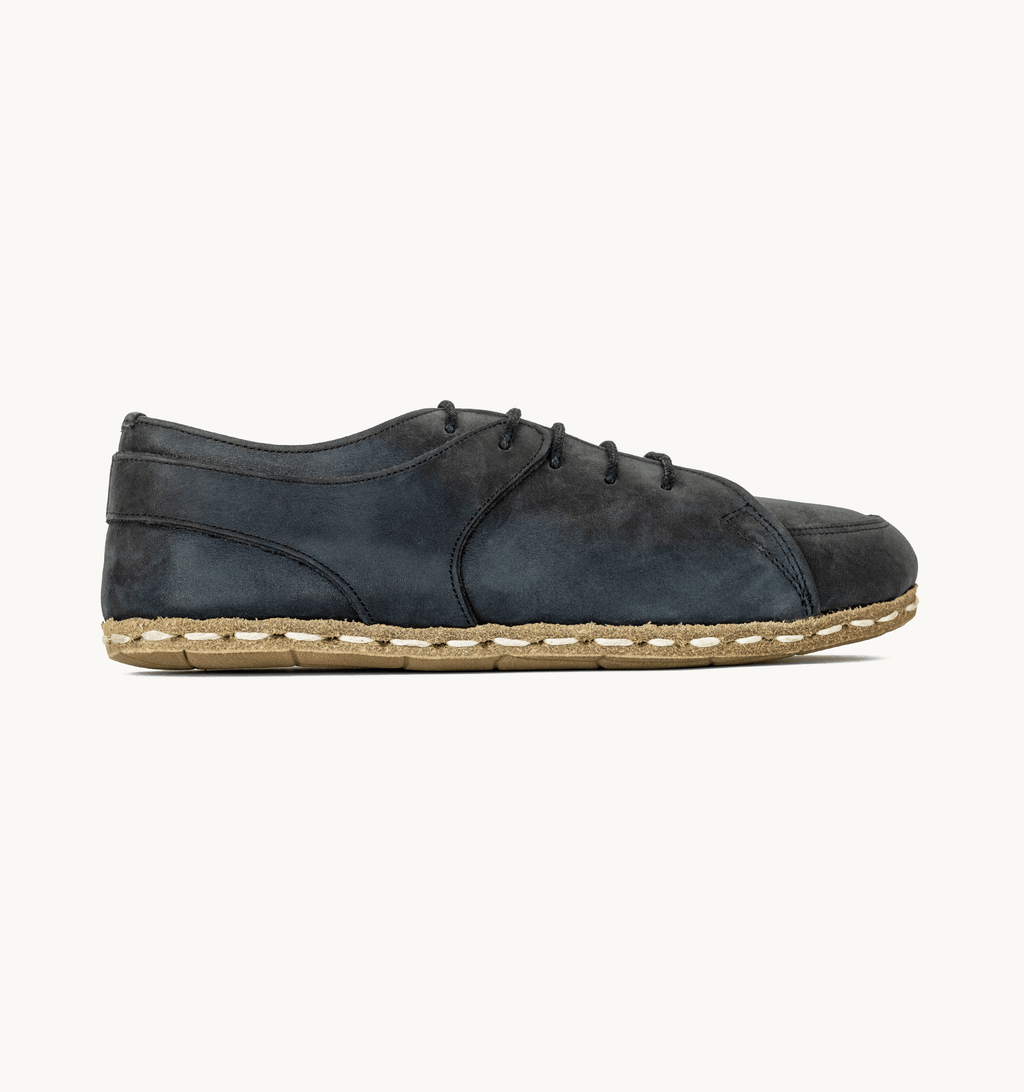 Raven Black men's barefoot leather sneaker, side view — hand-stitched, zero drop