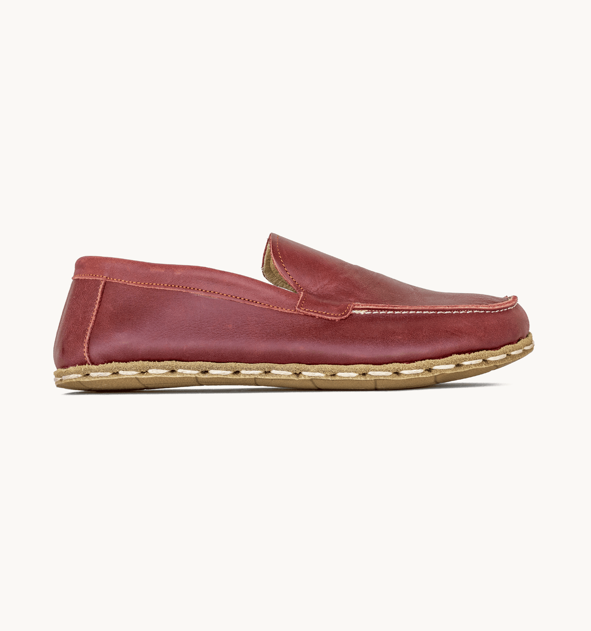 Burgundy women's barefoot leather moccasin, side view — hand-stitched, zero drop