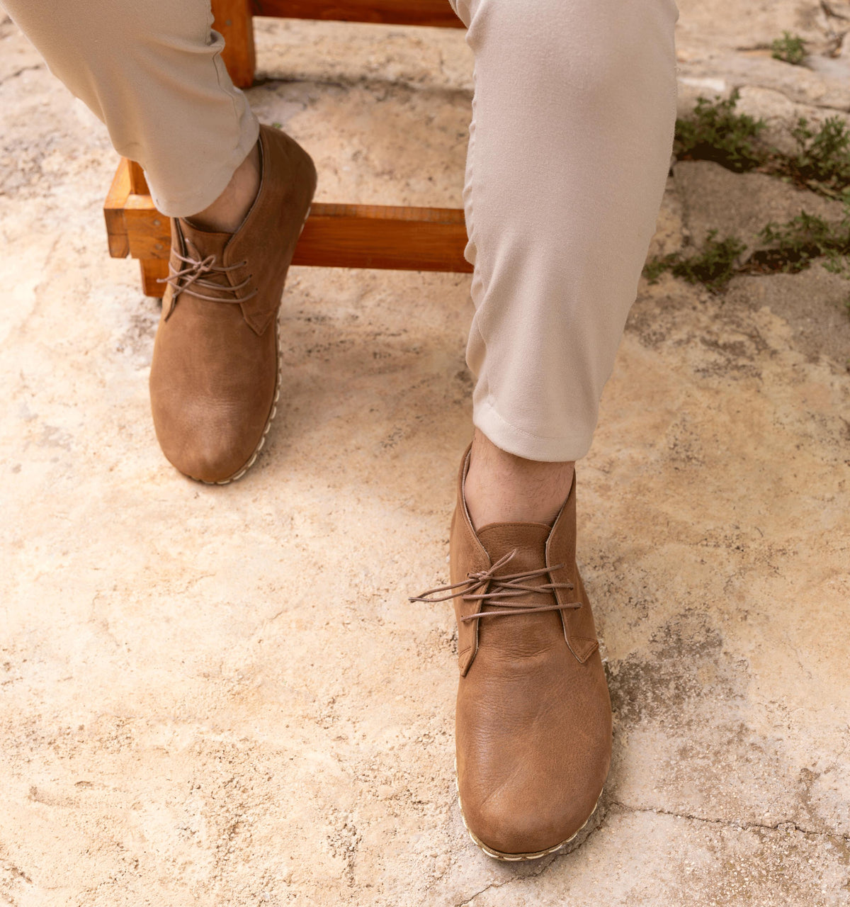 Hickory men's barefoot leather chukka boot held in hand, sole and stitch detail