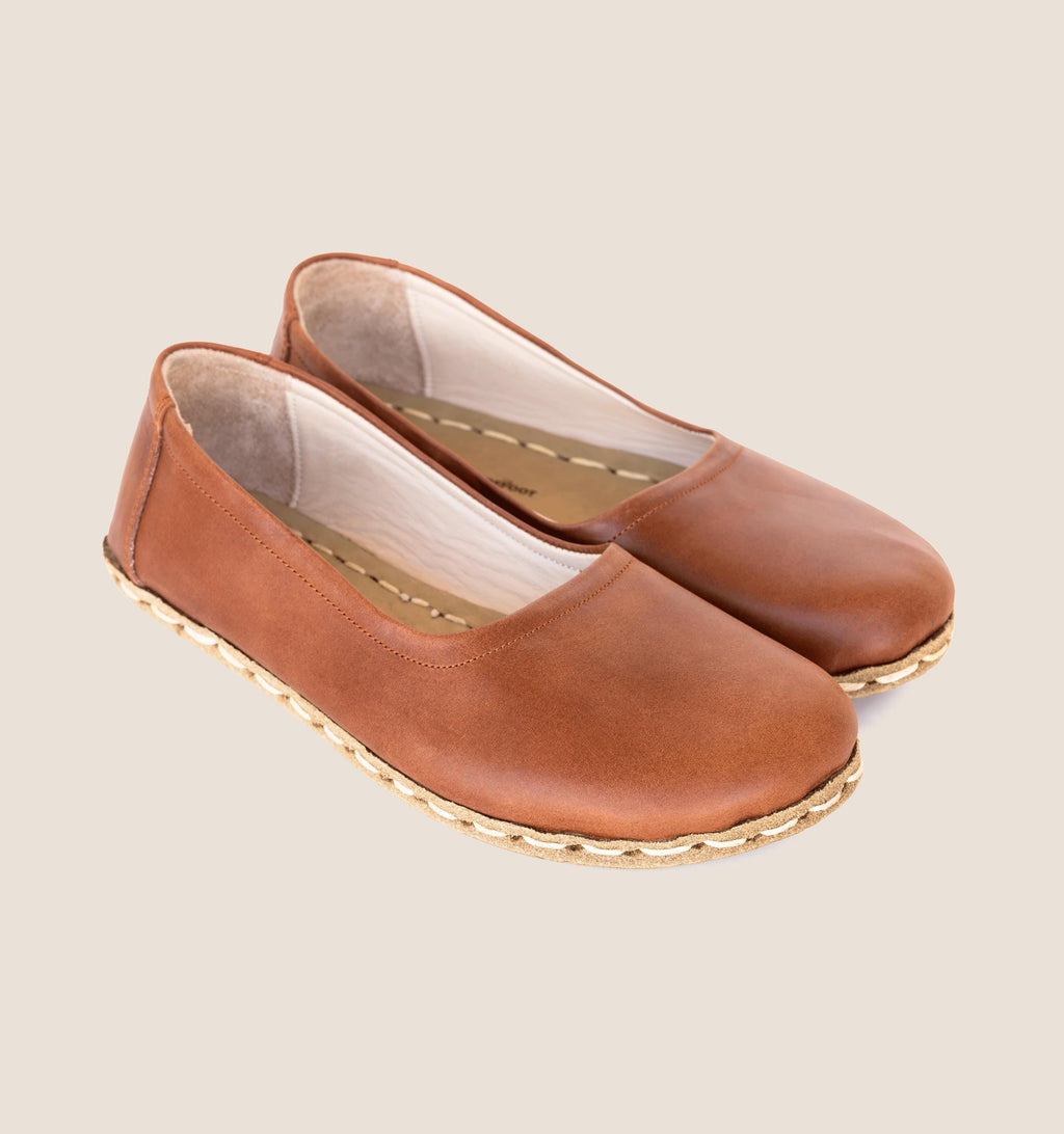 Umber women's barefoot leather ballet flat held in hand, sole and stitch detail