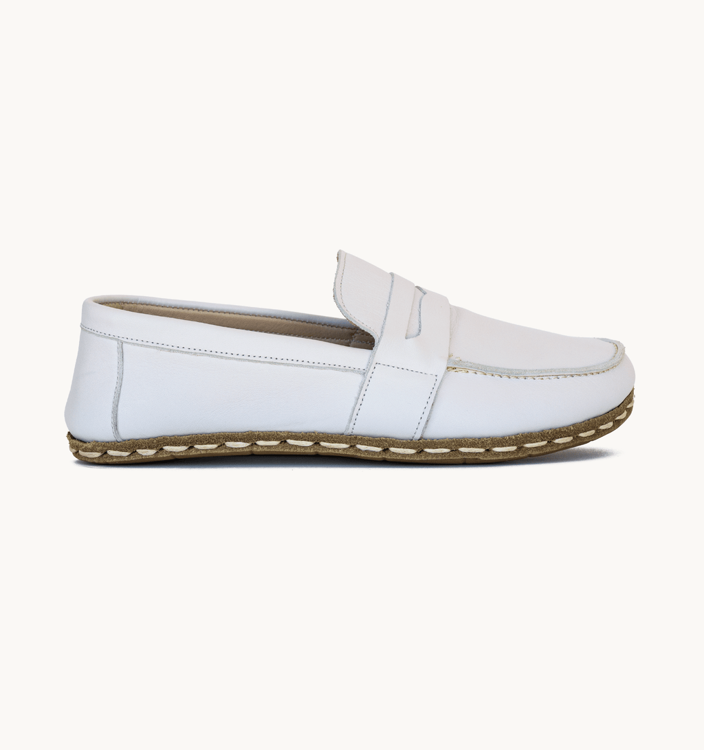 Cloud women's barefoot leather penny loafer held in hand, sole and stitch detail