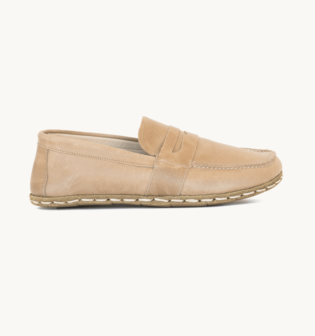 Sand men's barefoot leather penny loafer held in hand, sole and stitch detail