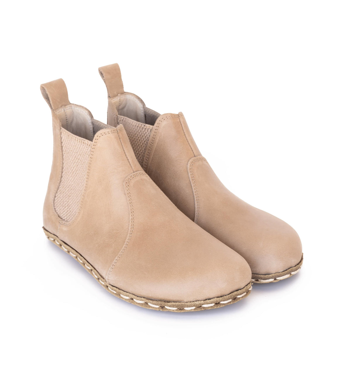 Sand men's barefoot leather chelsea boot held in hand, sole and stitch detail